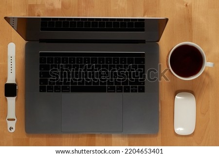 CONTENT CONCEPT Businessman tidy desktop with laptop, tablet, smartphone, financial reports and various objects, top view, coffee, free copyspace. High quality photo
