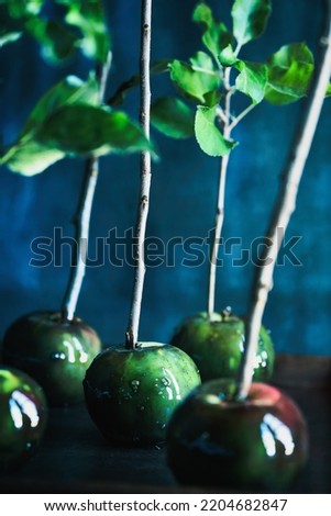 Poisoned green candied apples for Halloween. Selective focus on center apple with blurred foreground and background. 