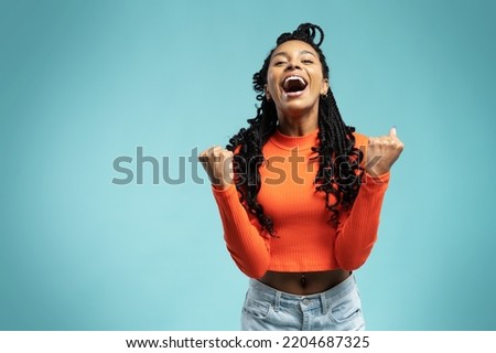 I won. Winning success happy woman celebrating being a winner. Dynamic image of female model on blue background. Victory, delight concept. Human facial emotions concept. Trendy colors Royalty-Free Stock Photo #2204687325