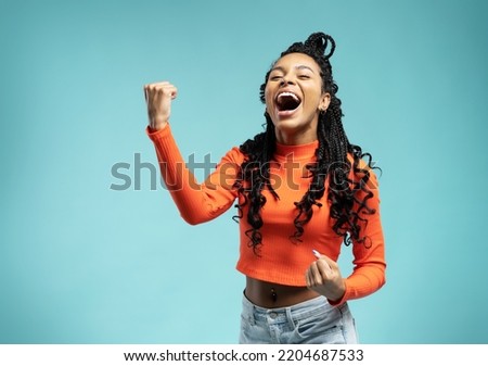 I won. Winning success happy woman celebrating being a winner. Dynamic image of female model on blue background. Victory, delight concept. Human facial emotions concept. Trendy colors Royalty-Free Stock Photo #2204687533