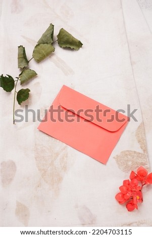Wedding invitation templates. pink envelope on a beige grunge background. Top view, flat lay.