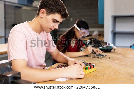 Diverse young high school students learning in science robotics or electronic engineering class Royalty-Free Stock Photo #2204736861