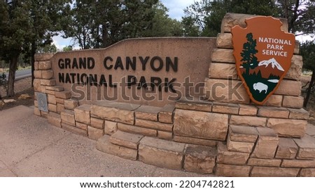 Grand Canyon National Park entrance sign nearby the South Entrance Station in northern Arizona, USA. The Grand Canyon is a steep-sided canyon carved by the Colorado River. Royalty-Free Stock Photo #2204742821