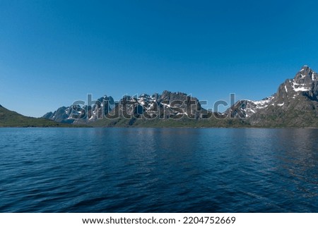 The mountains by a lake against the sky in Trollfjorden, Lofoten islands, Norway