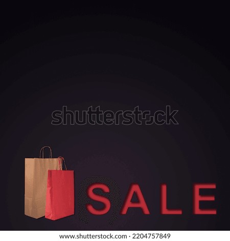 Banner with word sale and shopping bags on black background with copy space