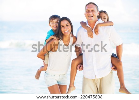 Happy Portrait of Mixed Race Family on the Beach