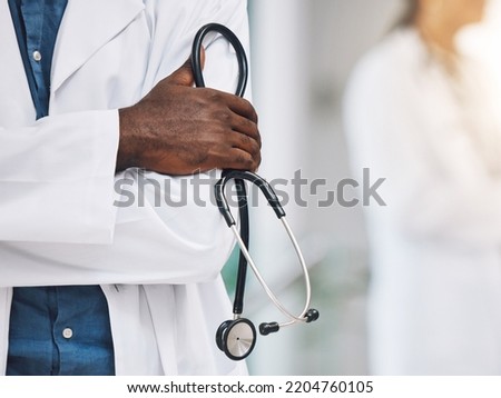 Healthcare, stethoscope in hand and African doctor in hospital. Black man or medical worker, leader in medicine and innovation in treatment. Confident, professional and expert patient care in Africa. Royalty-Free Stock Photo #2204760105