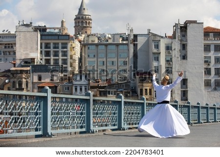 Sufi Whirling Dervish in the Galata Bridge, Beyoglu Istanbul, Turkey Royalty-Free Stock Photo #2204783401