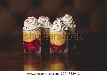 A closeup of trifles with creamy topping covered with sprinkles Royalty-Free Stock Photo #2204786913