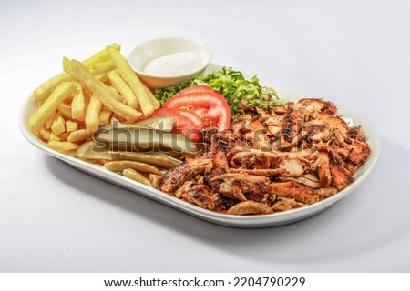 Chicken Shawarma plate with salad, fries served in a dish isolated on grey background side view of arabian fastfood Royalty-Free Stock Photo #2204790229
