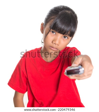 Bored young Asian girl with television remote control device over white background