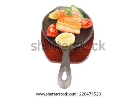 food: hot grilled salmon on metal pan over wooden plate isolated on white background