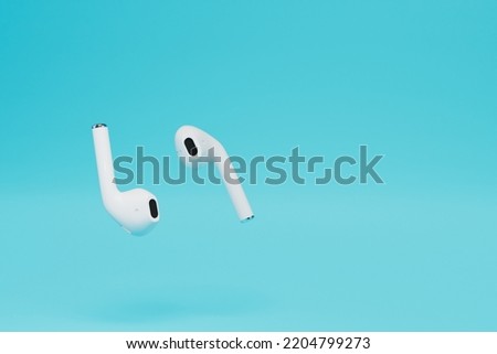 the concept of using wireless headphones. Wireless headphones on a blue background. copy paste, copy space. 3D render.