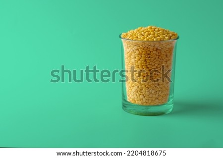 Gluten-Free Moong Dal or Yellow Lentil. Seamless Sea Green Color Background. 