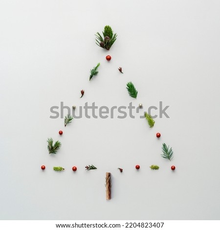 Christmas tree in the shape of a triangle on a white background. Creative Christmas tree layout. 