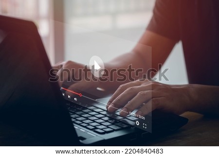 Video streaming on internet. Man hands using laptop computer for streaming and watching online movie, TV series, live concert, show or tutorial. Concept about subscription based live digital stream. Royalty-Free Stock Photo #2204840483