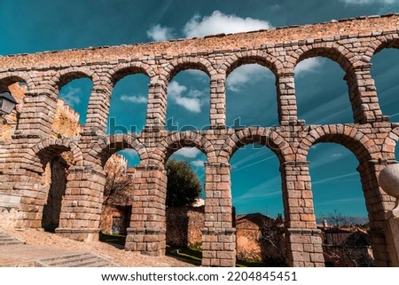 The ancient Roman aqueduct of Segovia, one of the best-preserved elevated Roman aqueducts and the foremost symbol of Segovia. Royalty-Free Stock Photo #2204845451