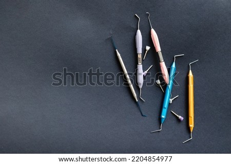 Gracie curettes and scalers on a black background. Dentist tools aesthetic view on a black background.
