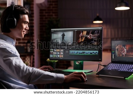 Male videographer editing movie footage with media software, working on film montage production. Creating video content with color grading and visual effects, using computer interface at home.