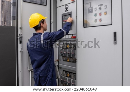 Construction electrician engineer caucasian man working with laptop in concept of good management electrical system for construction, logistic, import export transportation business in workplace area.