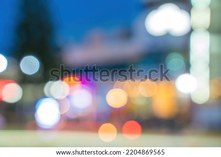 Abstract background of city street in bokeh. Blur focused urban abstract texture bokeh city lights. Design background Celebration