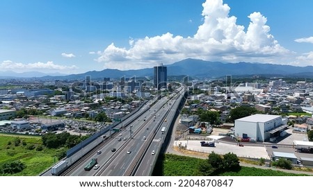 Aerial view of modern city and highway. Drone point of view. Royalty-Free Stock Photo #2204870847