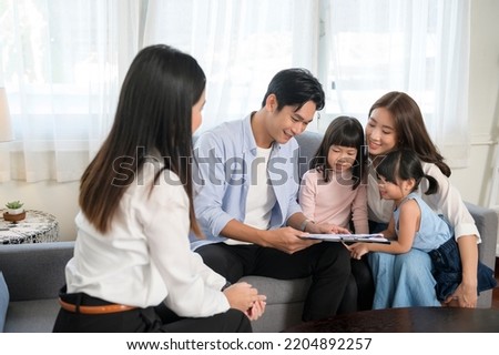 An Asian family meeting with female real estate agent or insurance consultant offering promotions , Mortgage, loan, property and medical health insurance concept. 