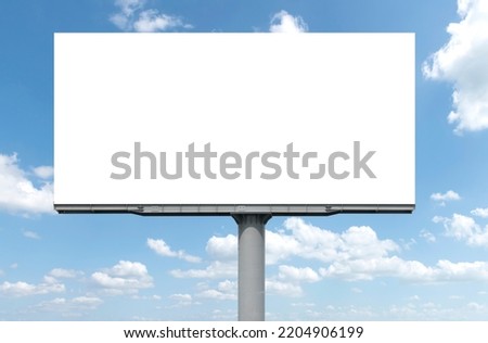Outdoor pole billboard with mock up white screen on blue sky background with clipping path Royalty-Free Stock Photo #2204906199