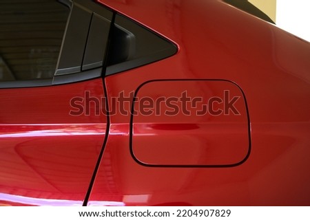 gas tank of glossy red car, transportation industry