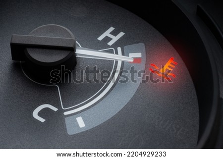 Needle pointer at the high temp point of the temperature gauge in the vehicle radiator and the symbol has the red light is on Royalty-Free Stock Photo #2204929233