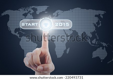Close up of finger touching a start button to start the future 2015 on a futuristic screen