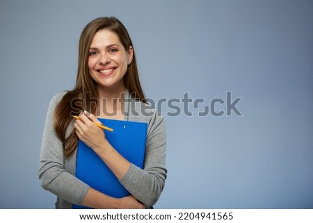 Smiling woman accountant ready for work with clipboard for tax report. Isolated portrait.