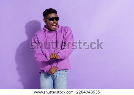Portrait of excited cheerful man enjoy chilling entertainment free time isolated on violet color background