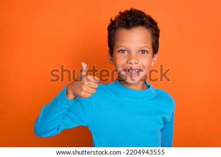 Close up photo of positive satisfied boy arm demonstrate yes symbol quality clothes stylish outfit isolated on orange color background