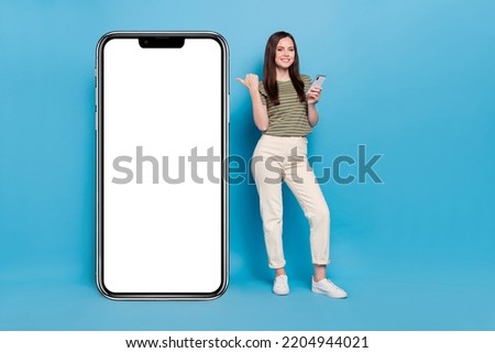 Full size photo of cute lady hold telephone index promo wear casual cloth isolated on blue background