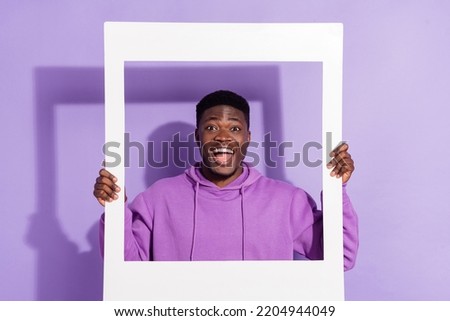 Portrait of funny person hands hold paper album card open mouth isolated on violet color background