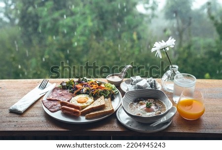 Breakfast on the wooden table at the cafe,rainy day