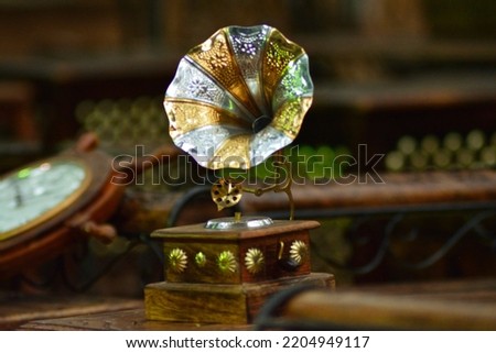 Image of an antique Gramophone. Miniature gramophone photo. Picture was taken in a flea market in an antique woodwork shop.