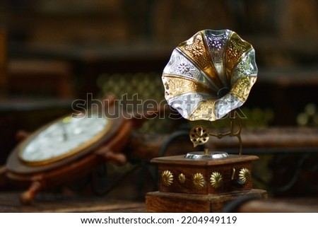 Image of an antique Gramophone. Miniature gramophone photo. Picture was taken in a flea market in an antique woodwork shop.