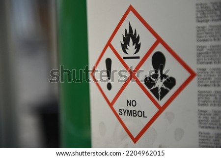 Red bounded GHS pictograms on a green drum with toxic liquid. Royalty-Free Stock Photo #2204962015