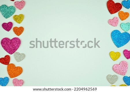 multi-colored shiny hearts on a white background on the left and right. A photo
