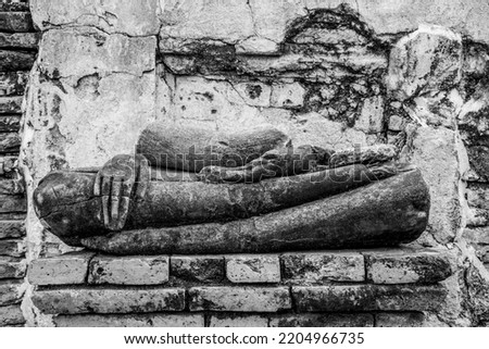 Legs of a buddha still in tact in black and white art