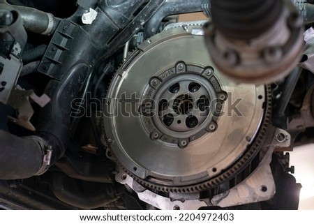 Detail of Car flywheel assembly in a workshop, car reparation engine