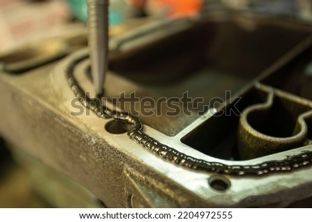 Detail of Sealant on the mechanical part Royalty-Free Stock Photo #2204972555