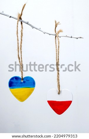 Hearts in the colors of the flag of Ukraine and Poland. White background