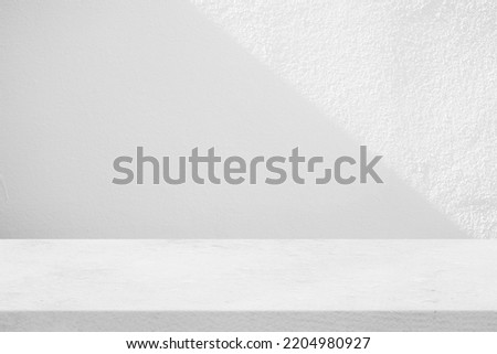 Concrete Table with White Stucco Wall Texture Background with Light Beam and Shadow, Suitable for Product Presentation Backdrop, Display, and Mock up.