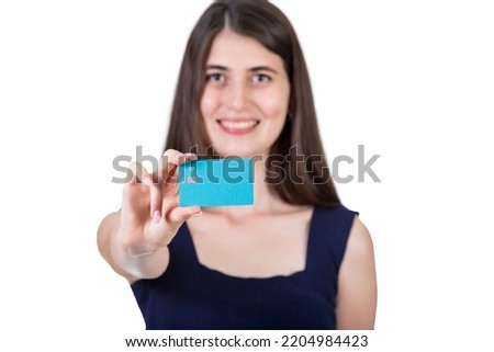 Happy young woman holding to camera a credit card. Close up portrait of a girl advertising a bank isolated on white background with copy space