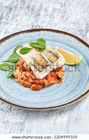 white fish with rice and vegetables
