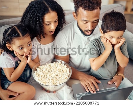 Family time, laptop and popcorn while watching a movie, streaming cartoons and looking shocked, surprised and scared. Wifi connection, online tv and bonding with kids, man and woman on couch at home