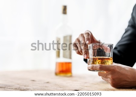 Sad depressed addicted drunk guy, Alone asian man drinker alcoholic sitting at bar counter with glass drinking whiskey. Royalty-Free Stock Photo #2205015093